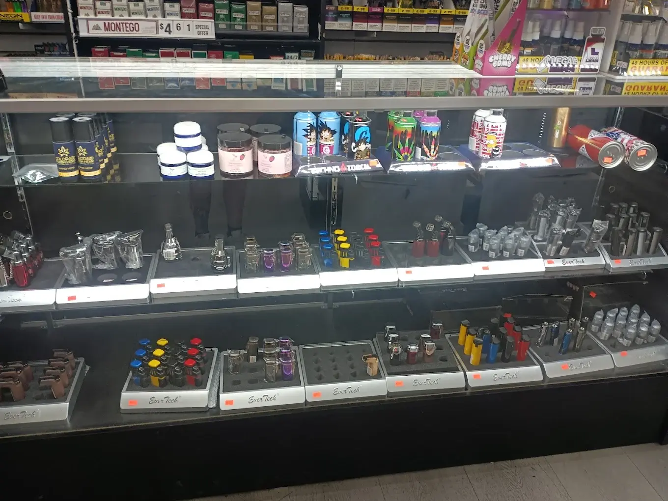 Display case of torch lighters, grinders, and CBD products.