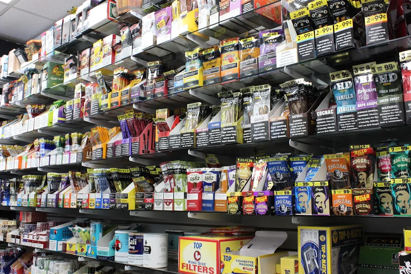 Wall of rolling papers, wraps, and cigarillos including RAW, Zig-Zag and HD brands.