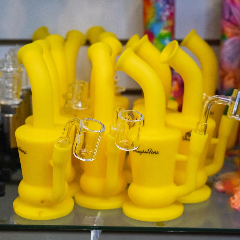 Cluster of yellow silicone smoking rigs on display.